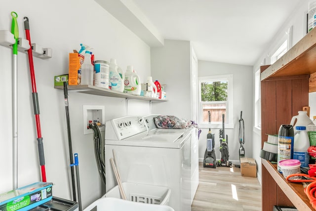 clothes washing area with laundry area, light wood-type flooring, and independent washer and dryer