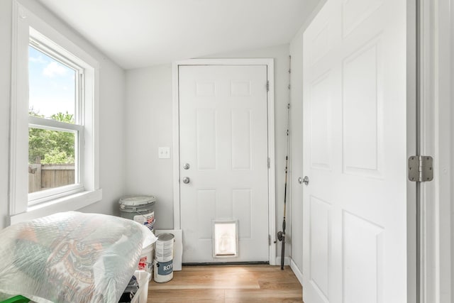interior space with vaulted ceiling and light wood finished floors