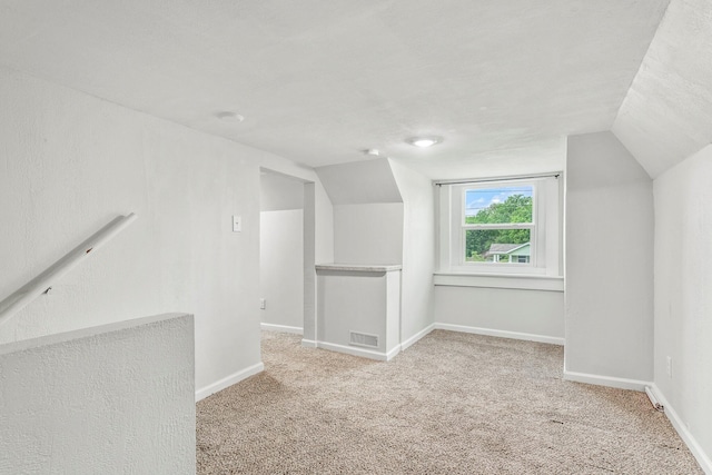 bonus room with visible vents, carpet flooring, baseboards, and vaulted ceiling