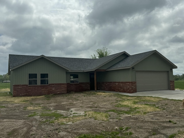 710 S High St, Mountain Grove, MO 65711 - view of front of home featuring roof with shingles, an attached garage, driveway, and brick siding