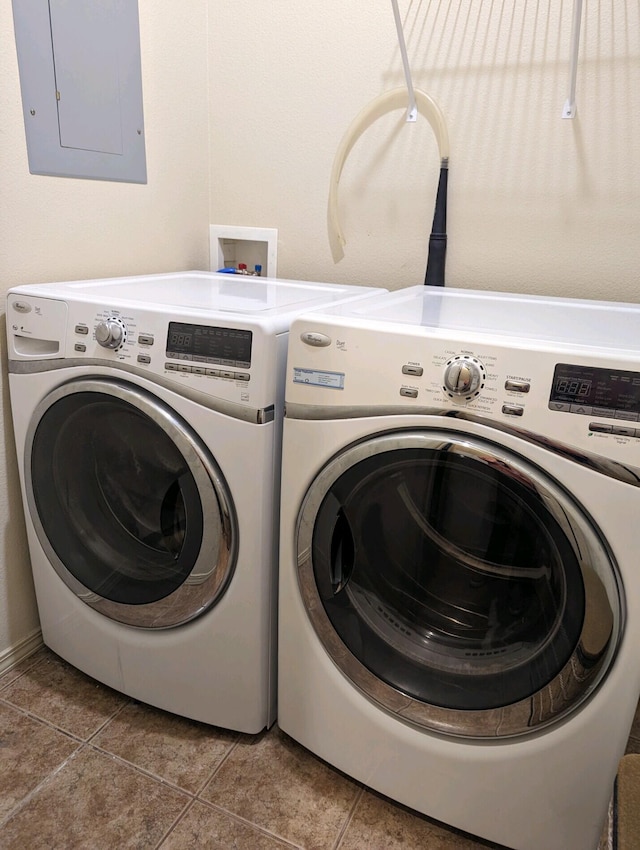 laundry room featuring separate washer and dryer, laundry area, tile patterned flooring, and electric panel