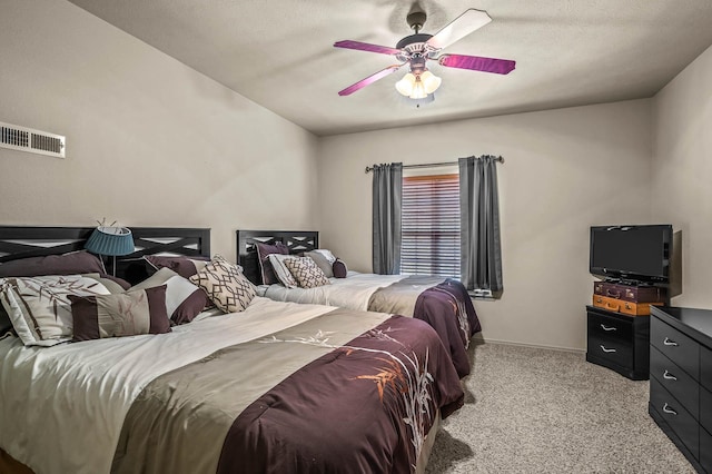 carpeted bedroom featuring baseboards, visible vents, and ceiling fan