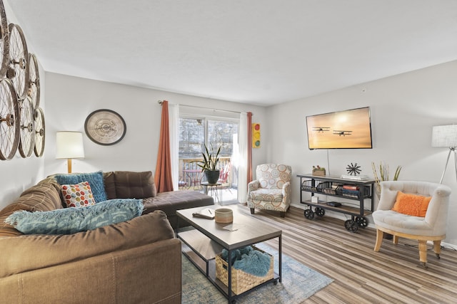 living room with baseboards and wood finished floors
