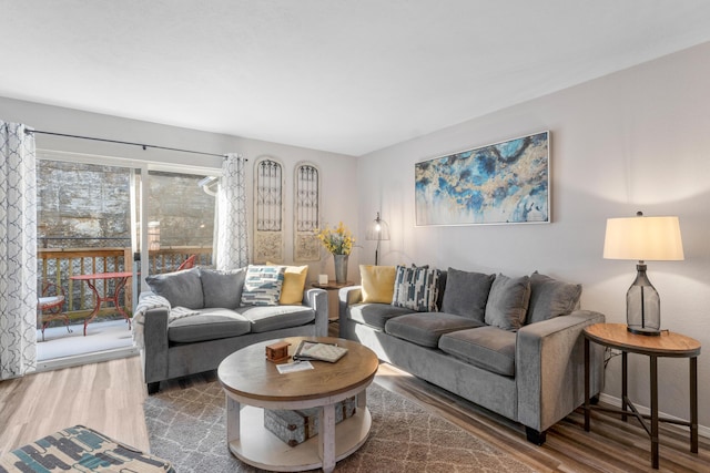 living room with baseboards and wood finished floors