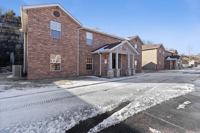 traditional-style house with brick siding and central AC