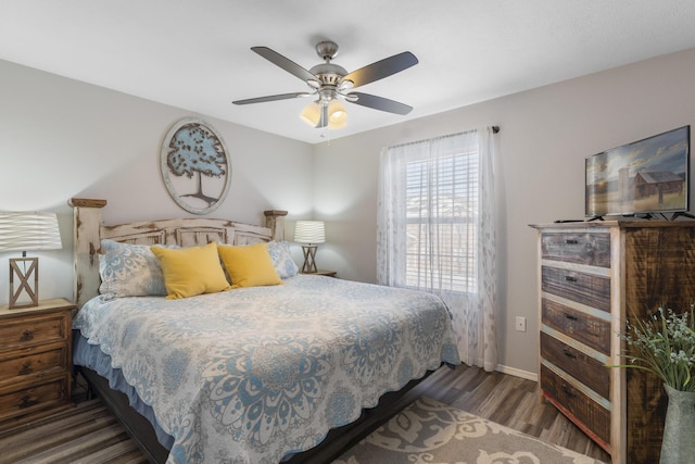bedroom featuring baseboards, ceiling fan, and wood finished floors