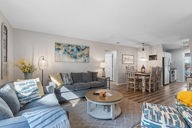 living area featuring baseboards and wood finished floors