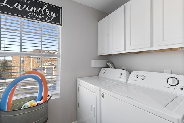 washroom featuring cabinet space and washer and dryer