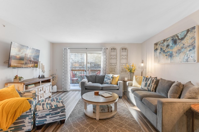 living area featuring baseboards and wood finished floors