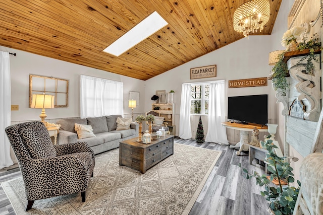 living room with wood ceiling, wood finished floors, a notable chandelier, and a skylight