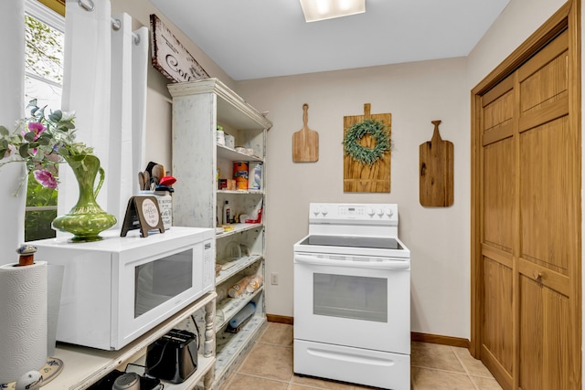 kitchen with baseboards, open shelves, white appliances, and light tile patterned flooring