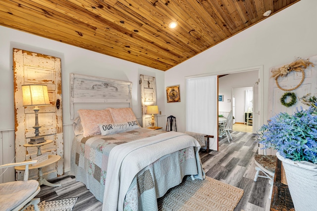 bedroom with vaulted ceiling, wood ceiling, and wood finished floors
