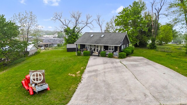 exterior space with a porch, driveway, and a front yard