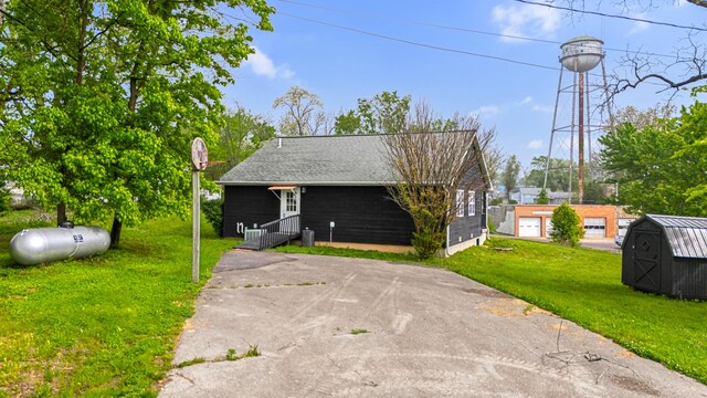 exterior space with an outdoor structure, a lawn, and a shed