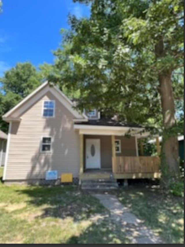 bungalow-style house with covered porch and a front yard