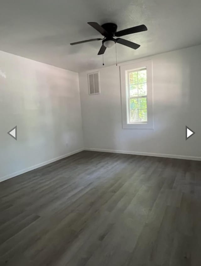 unfurnished room featuring visible vents, baseboards, ceiling fan, and dark wood-style floors