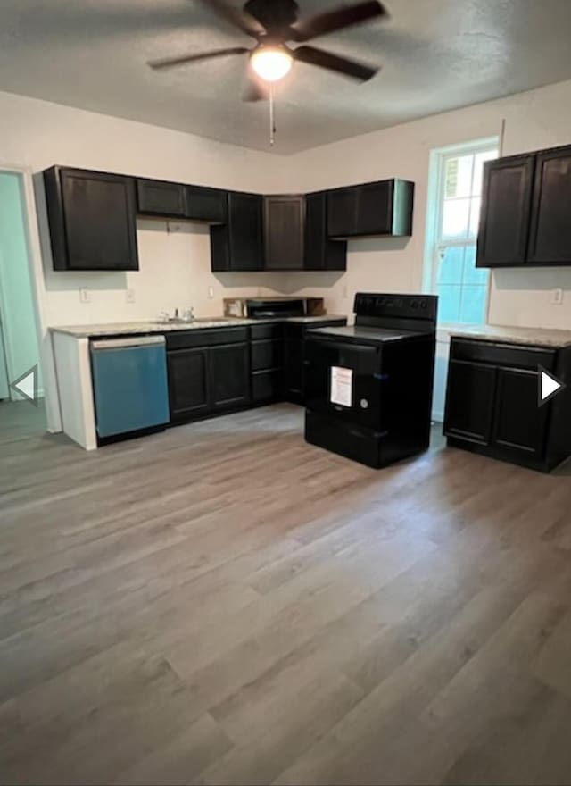 kitchen featuring black electric range oven, light wood-style floors, dishwashing machine, dark cabinets, and a ceiling fan