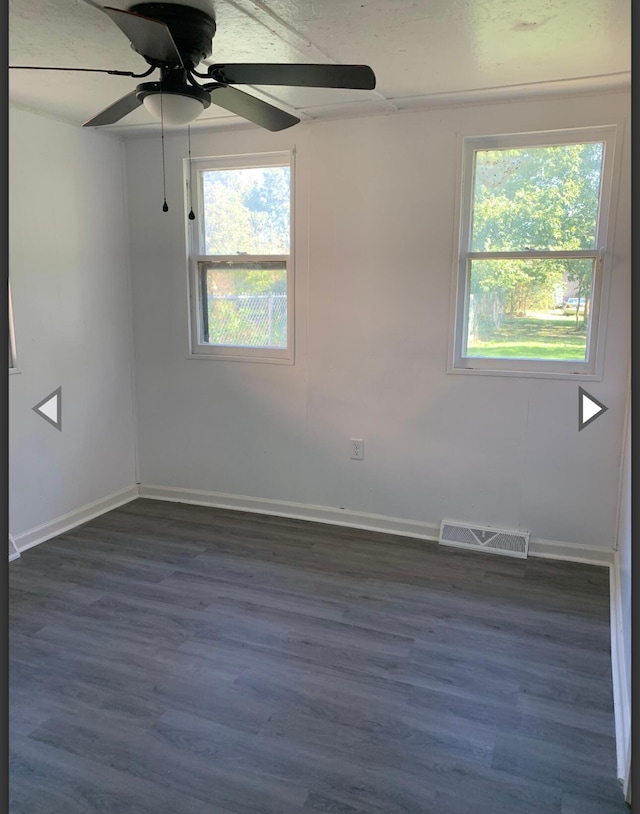 empty room with visible vents, baseboards, ceiling fan, and a wealth of natural light