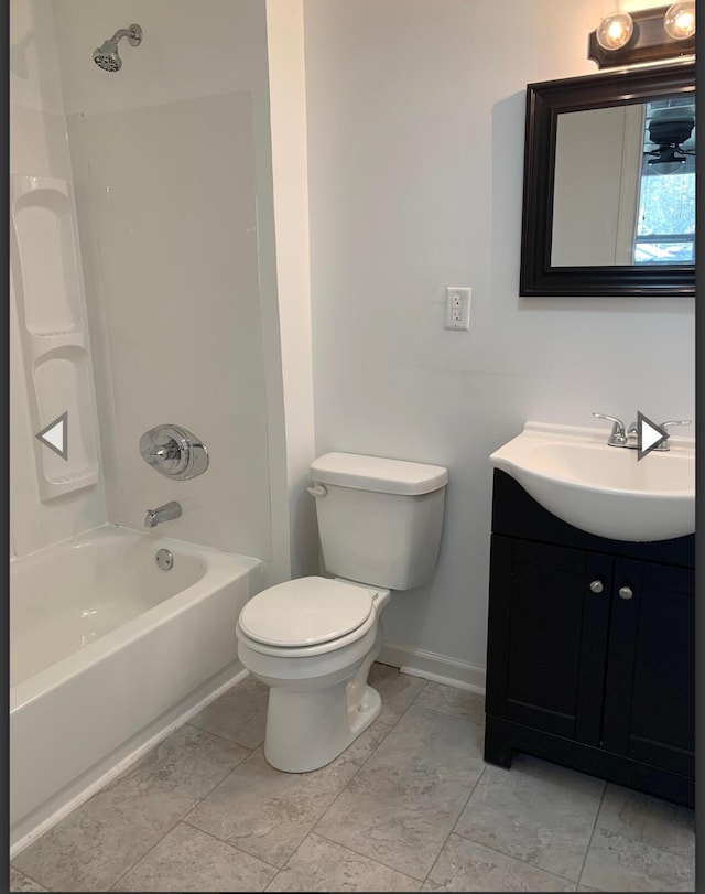 full bath with shower / bath combination, vanity, baseboards, and toilet