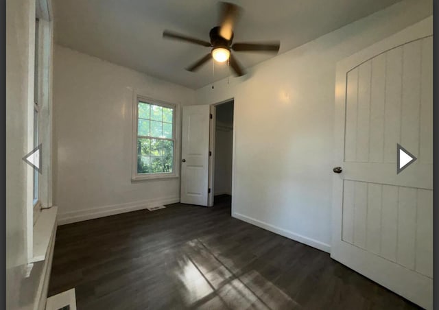 1327 W Livingston St, Springfield, MO 65803 - unfurnished bedroom with dark wood-type flooring, a ceiling fan, baseboards, and visible vents