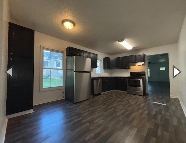 1327 W Livingston St, Springfield, MO 65803 - kitchen with dark wood-style flooring, stainless steel appliances, baseboards, and a textured ceiling