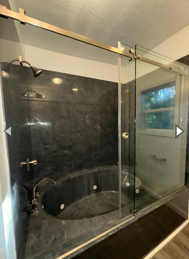 1327 W Livingston St, Springfield, MO 65803 - full bath featuring a jetted tub, a shower stall, and a textured ceiling