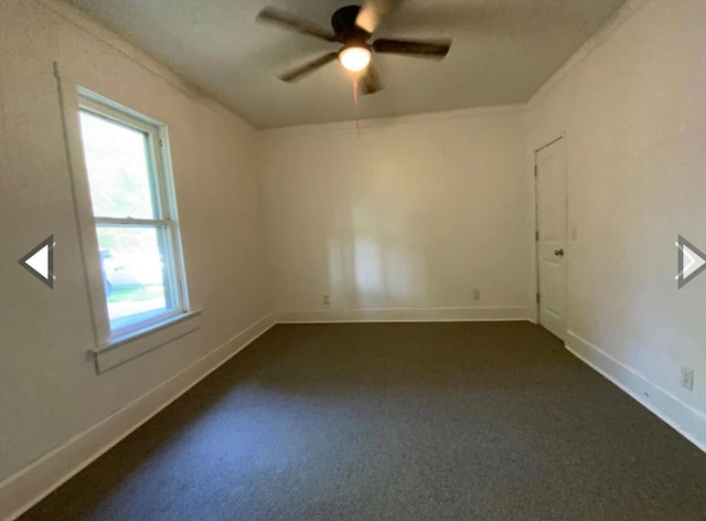 unfurnished room featuring baseboards, ceiling fan, ornamental molding, and dark carpet