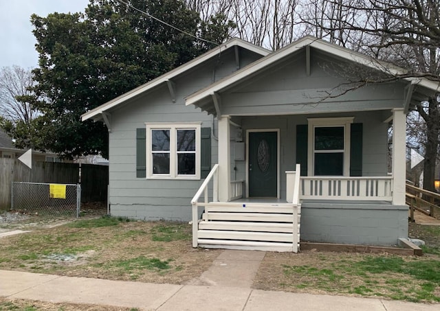 bungalow with fence and covered porch