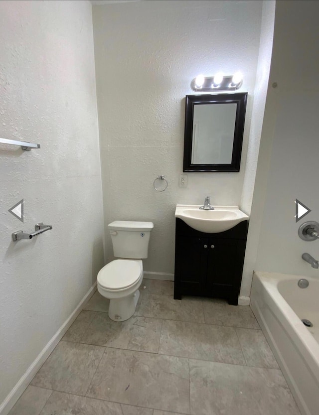 bathroom featuring vanity, baseboards, and toilet