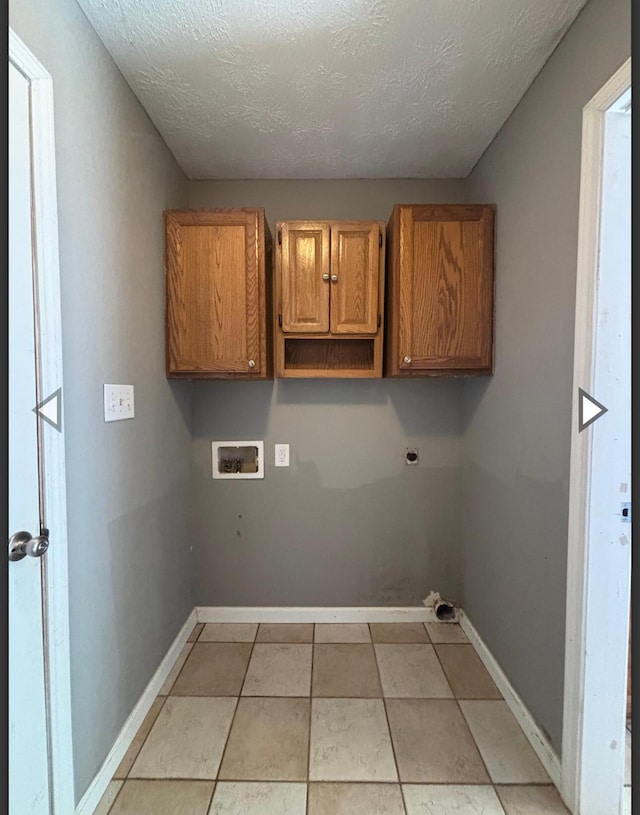 washroom featuring washer hookup, baseboards, electric dryer hookup, and cabinet space