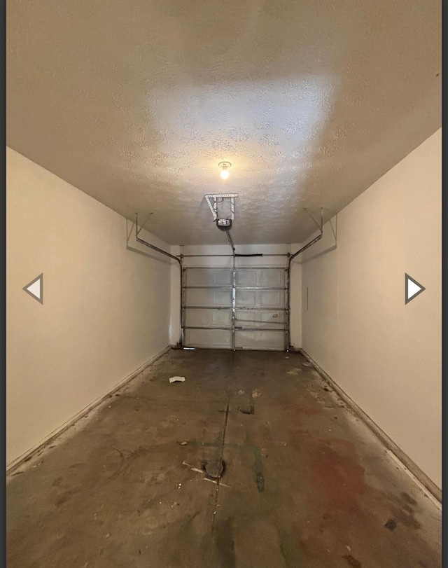 garage featuring baseboards and a garage door opener