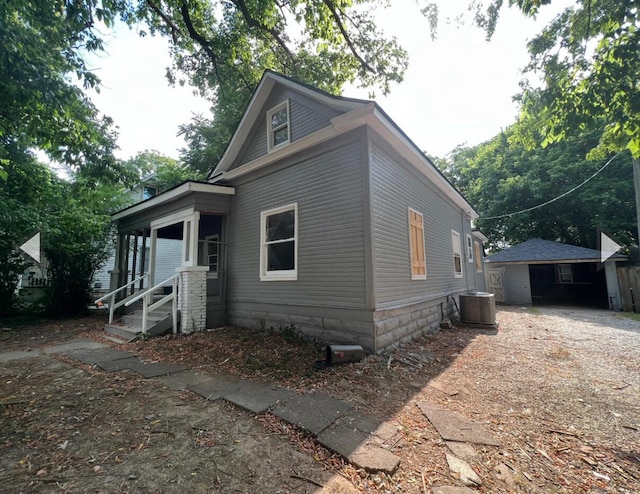 exterior space featuring cooling unit and driveway