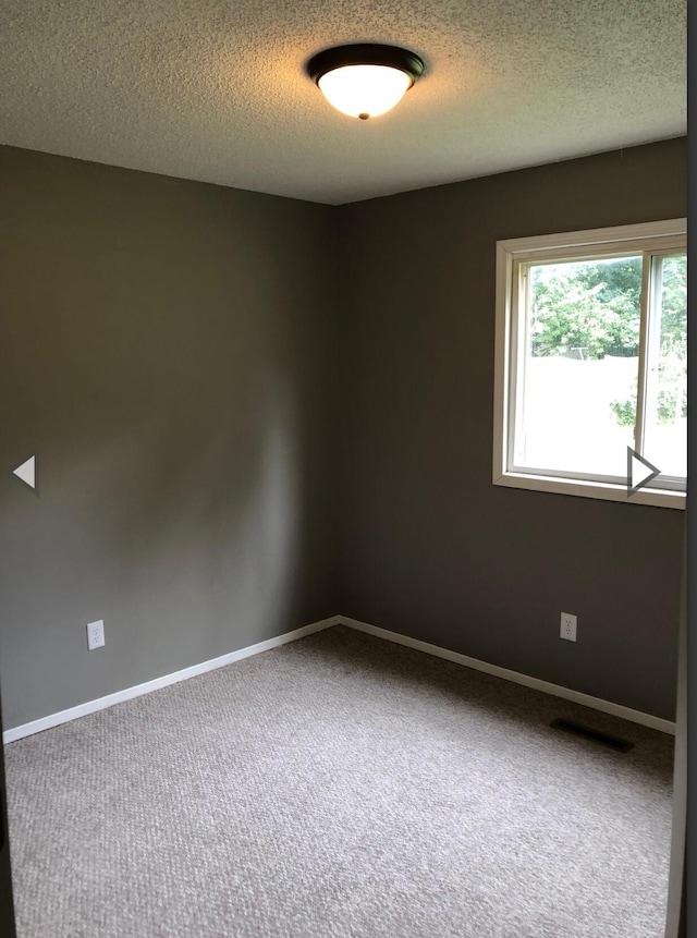 928 N Glenn Ave, Springfield, MO 65803 - spare room with carpet floors, a textured ceiling, visible vents, and baseboards