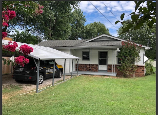 928 N Glenn Ave, Springfield, MO 65803 - rear view of house featuring brick siding, a shingled roof, a yard, and covered porch