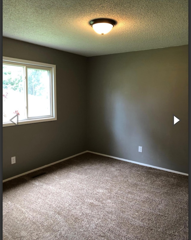 928 N Glenn Ave, Springfield, MO 65803 - empty room with carpet floors, a textured ceiling, and baseboards