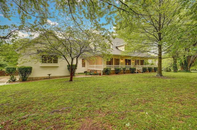 view of front of house featuring covered porch and a front lawn