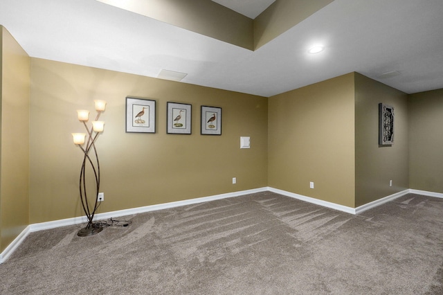 interior space featuring dark carpet, recessed lighting, and baseboards