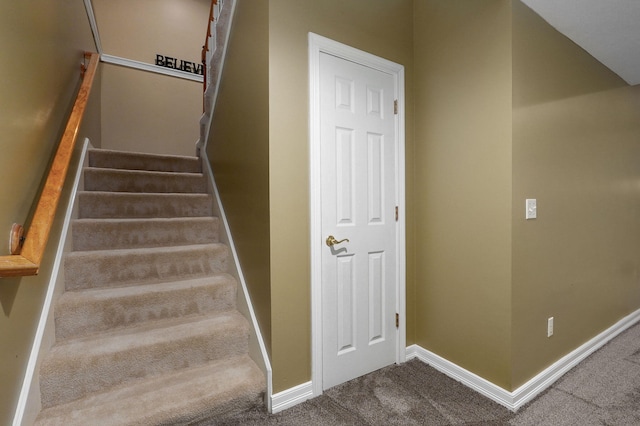 staircase with baseboards and carpet