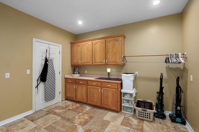 washroom featuring baseboards, stone finish floor, and recessed lighting
