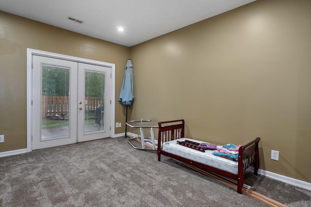carpeted bedroom with visible vents, baseboards, french doors, and access to exterior