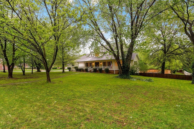 view of yard with fence and a porch