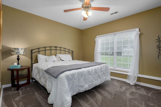 carpeted bedroom with a ceiling fan, baseboards, and visible vents