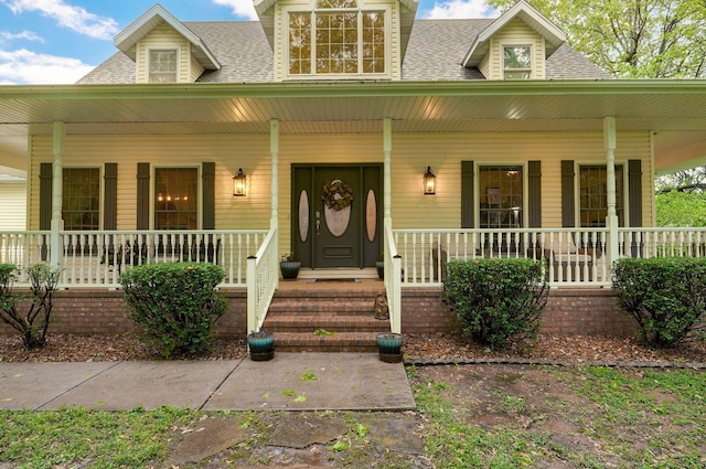 property entrance featuring a shingled roof and a porch