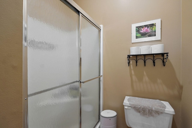 full bath with a shower stall and toilet