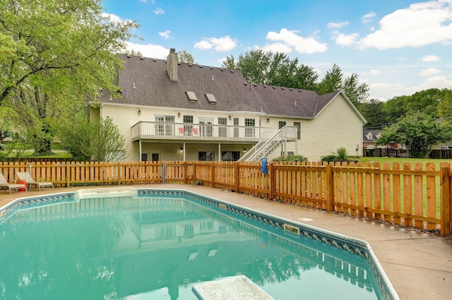 view of pool with a fenced in pool, a wooden deck, stairs, and a fenced backyard
