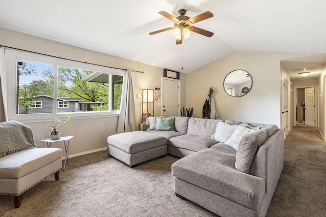 living room featuring baseboards, carpet flooring, a ceiling fan, and lofted ceiling