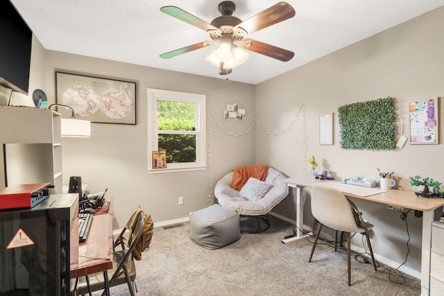 carpeted home office with baseboards and ceiling fan