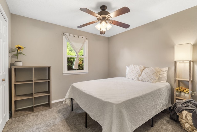 carpeted bedroom featuring baseboards, a ceiling fan, and a closet