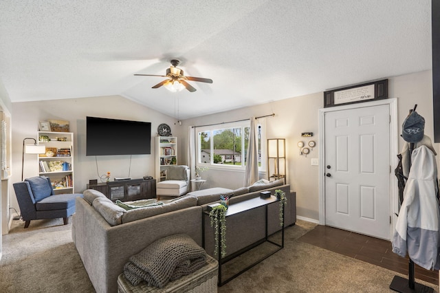 living room featuring a ceiling fan, a textured ceiling, vaulted ceiling, and dark carpet