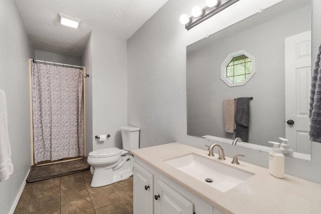 bathroom with a textured ceiling, tile patterned flooring, curtained shower, vanity, and toilet